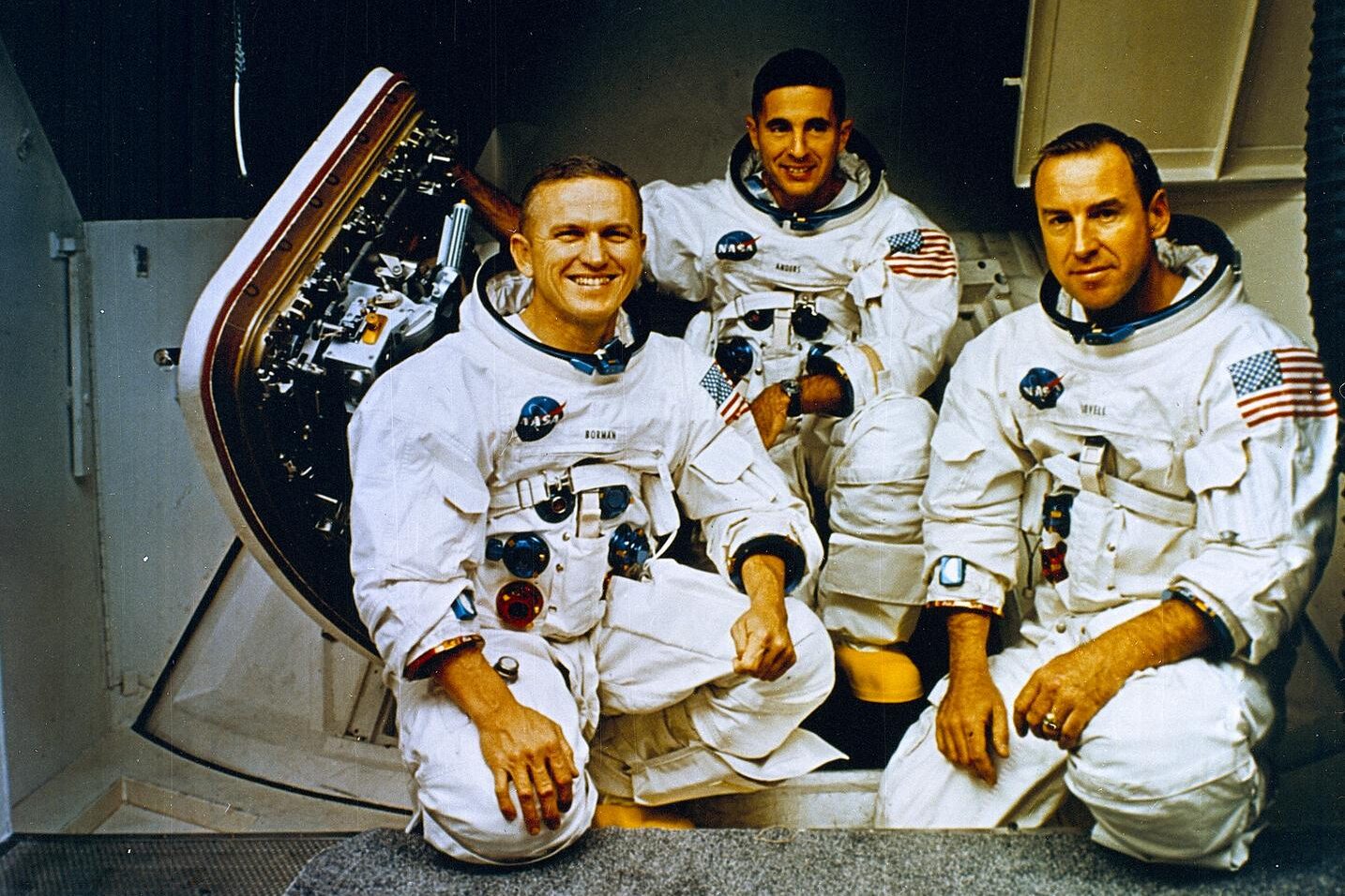 The Apollo 8 Crew (L to R) Frank Borman, commander; William Anders, Lunar Module (LM) Pilot; and James Lovell, Command Module (CM) pilot pose in front of the Apollo mission simulator during training.