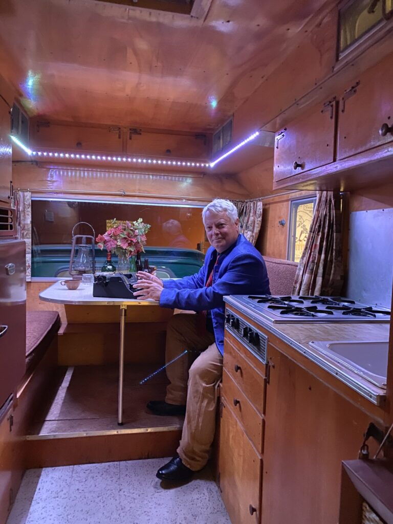 Clay sits at the table inside Steinbeck's famous truck-camper, Rocinante, during a visit to the National Steinbeck Center in Salinas, CA. 