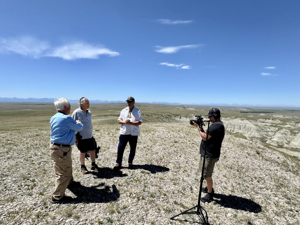 LTA Videographer, Nolan Johnson (far right), films Clay, Larry Epstein, and Jack Gladstone as they discuss what happened on the plains of Northern Montana in July 1806. (Photo Dennis McKenna)