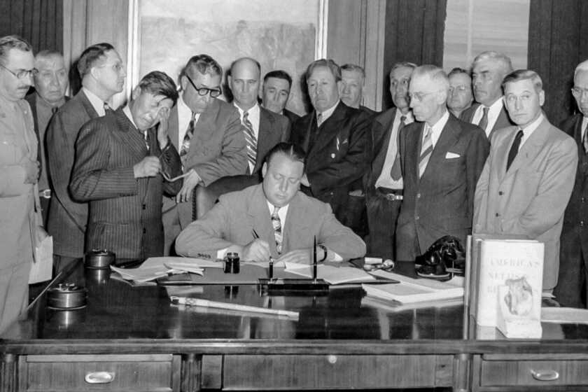 A photo of the signing of the Garrison Dam agreement on May 19, 1948. The man wiping away tears is George Gillette, chairman of the Mandan, Hidatsa, and Arikara Nation(MHA Nation or Three Affiliated Tribes). The agreement involved the forced sale of over 150,000 acres of MHA Nation land for the construction of the Garrison Dam and the creation of Lake Sakakawea. (National Archives)