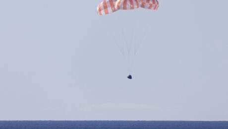 NASA’s Orion spacecraft under parachutes as it lands in the Pacific Ocean off the coast of California, Friday, April 10, 2026.