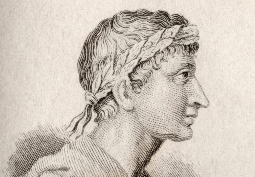 Engraved profile of a classical man with a laurel wreath on parchment background.