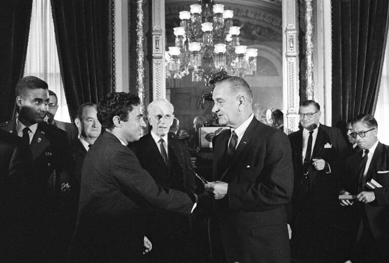 President Lyndon Johnson presents a signing pen from the Voting Rights Act to Richard Goodwin. August 6, 1965.